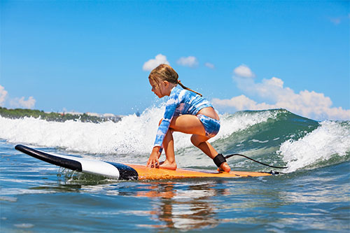 image of a smll girl surfing